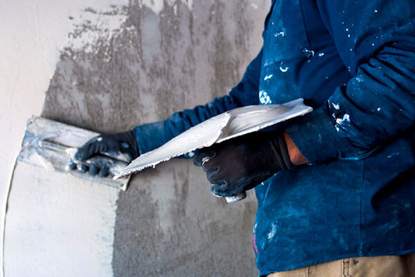 Worker Plastering Wall