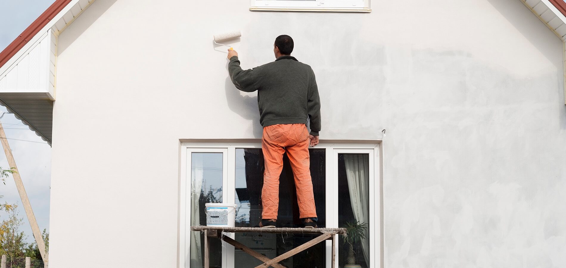 Worker Is Painting A Wall