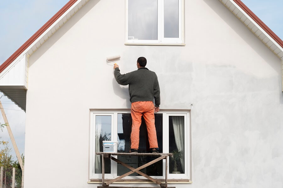 Worker Is Painting A Wall